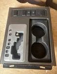 2007-2015 Nissan Armada Console Shifter Trim Bezel Switches & Cup Holder Oem Used. Price: $70.00.